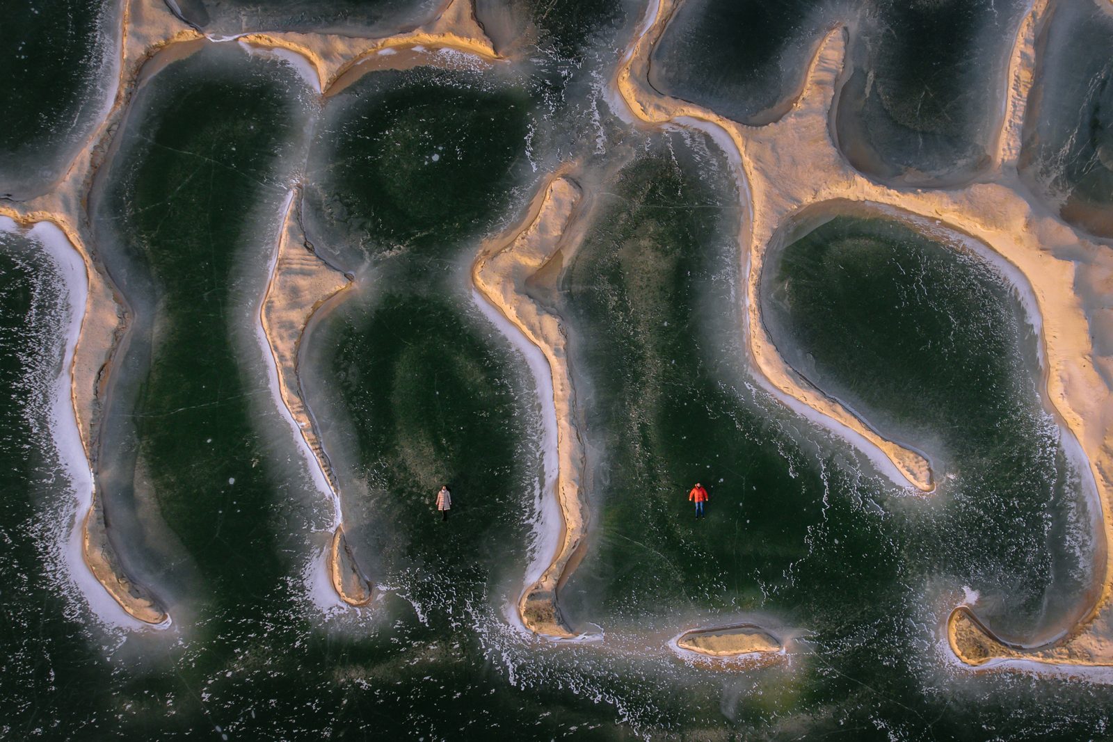 An aerial view of figures on patterned ground